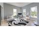Bright and light living room with two large windows, light walls and hardwood floors at 2732 Canebreak Ln, Mount Pleasant, SC 29466