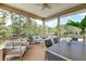 Relaxing screened porch with comfortable seating, ceiling fan, and views of the surrounding landscape at 2732 Canebreak Ln, Mount Pleasant, SC 29466