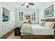 Cozy bedroom with natural light, ceiling fan, and a king-size bed with comfortable decor at 29 1/2 State St # B, Charleston, SC 29401