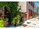Picturesque building entrance framed by lush greenery and colorful floral arrangements at 29 1/2 State St # B, Charleston, SC 29401