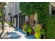 Elegant building entrance with lush greenery and floral arrangements at 29 1/2 State St # B, Charleston, SC 29401