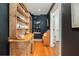 Hallway with hardwood floors, built-in shelves, and a view to other rooms in the house at 29 1/2 State St # B, Charleston, SC 29401