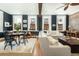 Charming living room featuring hardwood floors, exposed brick, lots of natural light, and stylish decor at 29 1/2 State St # B, Charleston, SC 29401