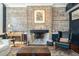 Elegant living room featuring exposed brick, a fireplace, and a stylish leather chair at 29 1/2 State St # B, Charleston, SC 29401