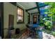 Charming patio with a black cast iron table set in a shaded area, ideal for relaxation or dining at 29 1/2 State St # B, Charleston, SC 29401