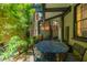 Beautiful patio with a black cast iron table, surrounded by lush greenery for a serene outdoor dining space at 29 1/2 State St # B, Charleston, SC 29401