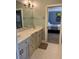 Bathroom with dual sink vanity, tiled floors, and a view into an adjacent bedroom at 3017 Ashburton Way, Mount Pleasant, SC 29466