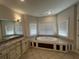 Bright bathroom featuring a large tub, tiled floors, and double vanity with granite countertop at 3017 Ashburton Way, Mount Pleasant, SC 29466