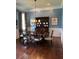 Formal dining room boasts wood floors, stylish decor, wainscotting, and elegant chandelier at 3017 Ashburton Way, Mount Pleasant, SC 29466