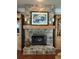 Living room fireplace with stone surround, carved wood mantle and custom built-in shelving at 3017 Ashburton Way, Mount Pleasant, SC 29466