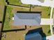 Overhead aerial view of fenced backyard, roof, and small outdoor seating area at 303 Feldspar Ln, Ladson, SC 29456