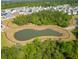 Aerial view of a community pond, walking trail, and homes in a well-planned neighborhood at 303 Feldspar Ln, Ladson, SC 29456