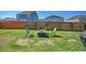 Spacious backyard featuring a well-maintained lawn and cozy seating area around a fire pit at 303 Feldspar Ln, Ladson, SC 29456