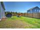 Extensive backyard with lush grass, a wooden fence, and a barbecue grill on the patio at 303 Feldspar Ln, Ladson, SC 29456