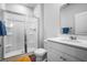 Bright bathroom featuring a glass-door shower, white vanity and modern fixtures at 303 Feldspar Ln, Ladson, SC 29456