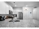 Bright kitchen featuring white cabinets, granite countertops, stainless steel appliances, and modern fixtures at 303 Feldspar Ln, Ladson, SC 29456