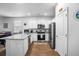 Bright kitchen featuring white cabinets, granite countertops, stainless steel appliances, and modern fixtures at 303 Feldspar Ln, Ladson, SC 29456
