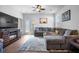 Inviting living room with a plush gray sectional, stylish decor, and natural light streaming through the window at 303 Feldspar Ln, Ladson, SC 29456