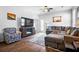 Inviting living room with a plush gray sectional, stylish decor, and natural light streaming through the window at 303 Feldspar Ln, Ladson, SC 29456