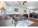 Open-concept space with living, dining, and kitchen areas filled with natural light and modern furnishings at 303 Feldspar Ln, Ladson, SC 29456