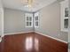 Bright bedroom features hardwood floors, modern ceiling fan, and white-trimmed windows at 304 Pimpernel St, Summerville, SC 29483