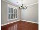 Dining room boasting hardwood floors, a chandelier, and a large window with shutter style blinds at 304 Pimpernel St, Summerville, SC 29483