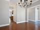 Open dining room adjacent to kitchen showcases hardwood floors and elegant light fixture at 304 Pimpernel St, Summerville, SC 29483