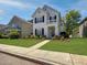 Charming two-story home with a balcony, lush landscaping, and a well-manicured front lawn at 304 Pimpernel St, Summerville, SC 29483