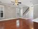 Spacious living room with hardwood floors, a ceiling fan, and a staircase leading to the upper level at 304 Pimpernel St, Summerville, SC 29483