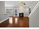 Bright living room features a cozy fireplace, ceiling fan, and rich hardwood floors at 304 Pimpernel St, Summerville, SC 29483