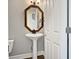 Quaint powder room featuring a pedestal sink and decorative mirror at 304 Pimpernel St, Summerville, SC 29483