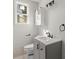 Modern bathroom with updated vanity, toilet, sink and sleek lighting fixture at 3113 Matipan Ave, North Charleston, SC 29405