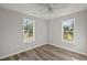 Inviting bedroom featuring modern ceiling fan, hardwood flooring, and dual windows at 3113 Matipan Ave, North Charleston, SC 29405