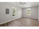 Bright bedroom featuring modern ceiling fan, hardwood flooring and dual windows for natural light at 3113 Matipan Ave, North Charleston, SC 29405
