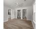 Open bedroom leading to bathroom and closet, featuring modern ceiling fan, and hardwood flooring at 3113 Matipan Ave, North Charleston, SC 29405