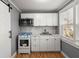 The updated kitchen has white cabinets, new microwave, range, and a sliding barn door at 3113 Matipan Ave, North Charleston, SC 29405