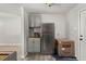 Efficient kitchenette with stainless steel refrigerator, sleek cabinetry and grey countertops at 3113 Matipan Ave, North Charleston, SC 29405