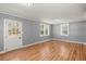Bright living room featuring laminate flooring, a glass paneled door, and abundant natural light at 3113 Matipan Ave, North Charleston, SC 29405