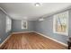 An open living space with laminate flooring, neutral gray walls, and plenty of light from the windows at 3113 Matipan Ave, North Charleston, SC 29405