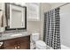 Bathroom featuring a granite countertop, dark wood cabinets and a shower with black and white checkered curtain at 315 Fish Creek Ct, Summerville, SC 29486