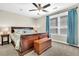 Bedroom featuring a large bed with patterned bedding, chest at foot and large window with blue curtains at 315 Fish Creek Ct, Summerville, SC 29486