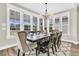 Well-lit dining room with large windows, a chandelier, and seating for eight guests at 315 Fish Creek Ct, Summerville, SC 29486