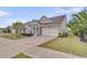 Beautiful one-story home showcasing a two-car garage, lush landscaping, and inviting front entrance at 315 Fish Creek Ct, Summerville, SC 29486