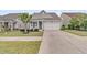 Inviting one-story home featuring a well-manicured lawn, two-car garage, and cozy front porch at 315 Fish Creek Ct, Summerville, SC 29486