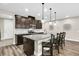 Spacious kitchen features dark wood cabinets, stainless steel appliances, granite countertops, and a large island at 315 Fish Creek Ct, Summerville, SC 29486