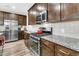 Updated kitchen featuring stainless steel appliances, granite countertops, dark cabinets, and tile backsplash at 315 Fish Creek Ct, Summerville, SC 29486