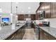 Modern kitchen boasts stainless steel appliances, granite countertops, dark cabinets, and hardwood floors at 315 Fish Creek Ct, Summerville, SC 29486