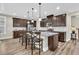Spacious kitchen features dark wood cabinets, stainless steel appliances, granite countertops, and island seating at 315 Fish Creek Ct, Summerville, SC 29486