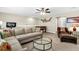 Spacious living room featuring sectional couch, glass coffee table, foosball table, and leather chair at 315 Fish Creek Ct, Summerville, SC 29486