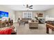 Living room featuring sectional couch, glass coffee table, exercise bike, and a wall-mounted television at 315 Fish Creek Ct, Summerville, SC 29486